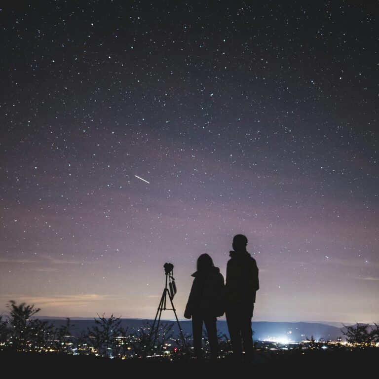 A couple stargazes under a starry sky in Elkton, VA, capturing the beautiful Milky Way.